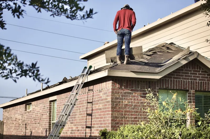 Professional roofer working on a residential roof in Fountain View